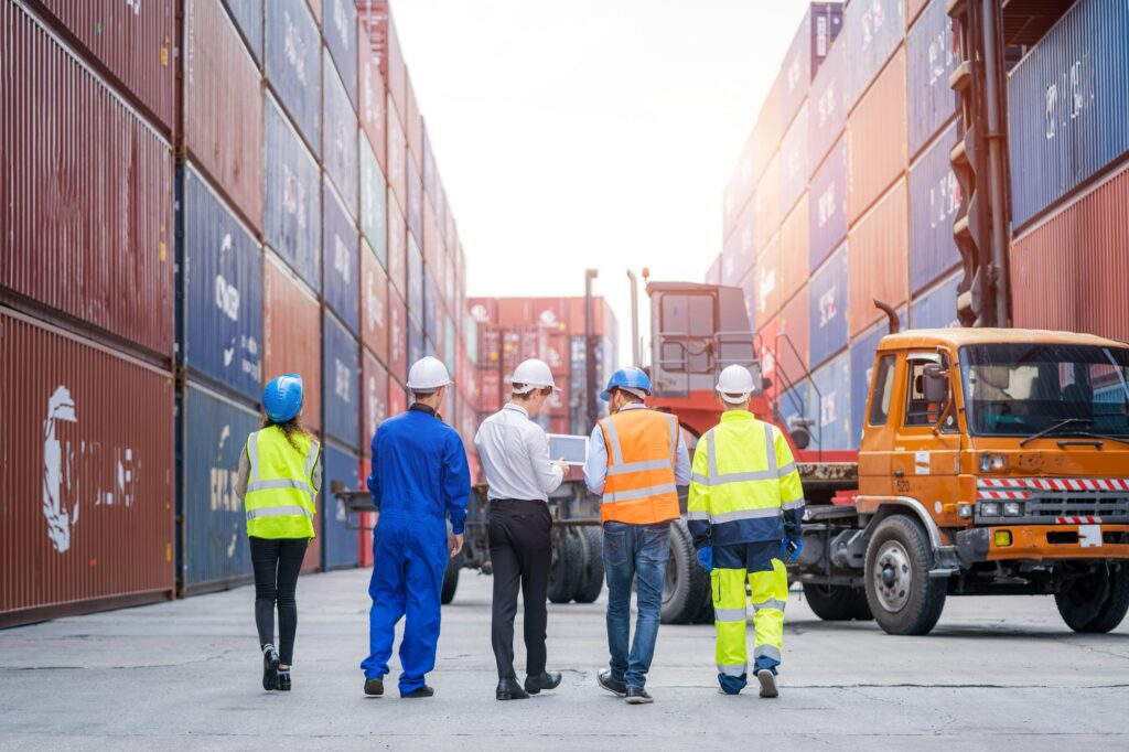 Engineer team planning the transportation of goods for import or export in the container yard.
